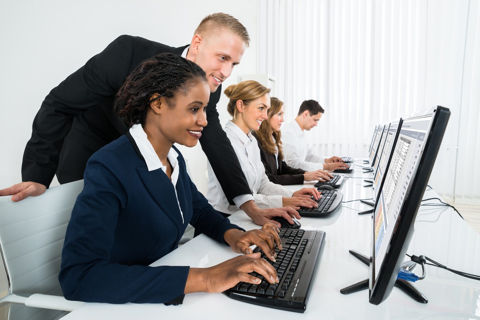 Young Happy Manager Assisting His Female Staff In Office